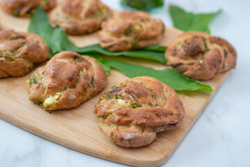 home made whole grain bread rolls with wild garlic on a table