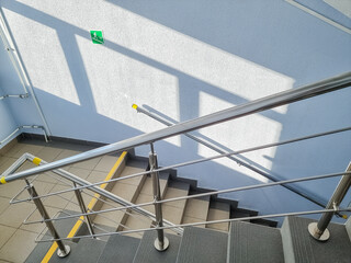 modern metal staircase.Looking down at a modern staircase with white wall as to be found in an...