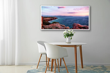 Modern TV set hanging on light wall in dining room