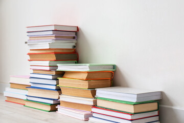 Stack of books near light wall in room