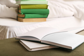 Books on bed in room, closeup