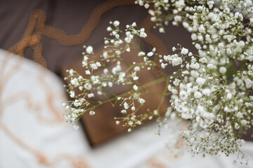 In the foreground are gypsophila flowers, in the background a book