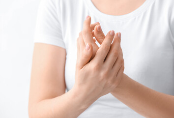 Young woman applying cream on her hands, closeup