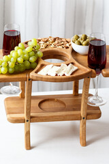 Serving wooden table for wine, glasses and snacks. Handmade segmented Portion wooden table. Grapes, cheese, wine and nuts.  