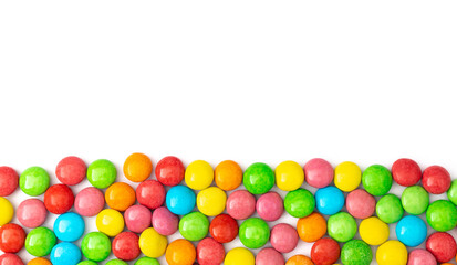 close up of colorful candies on white background with space for text.