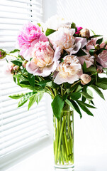 Beautiful pink peony bouquet in a vase.