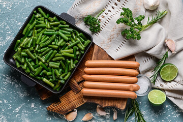 Composition with tasty sausages and green beans on color background