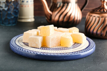 Plate with Turkish delight on dark background