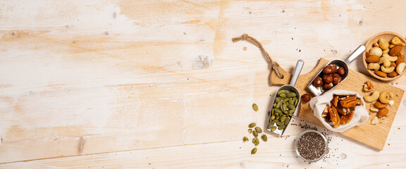 Mixed nuts for healthy start breakfast on wooden background with copy space