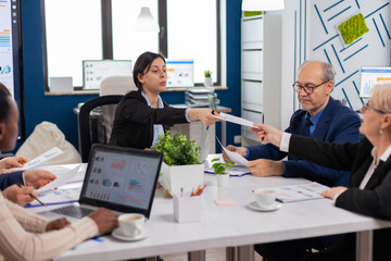 Group of diverse business people having a meeting in conference room. Businesswoman discussing ideas with colleagues about financial strategy for new start up company.