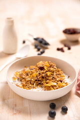 Breakfast cereal with milk in white bowl