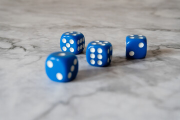 rolling dice on the white marble table surface