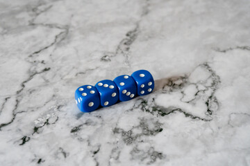 rolling dice on the white marble table surface