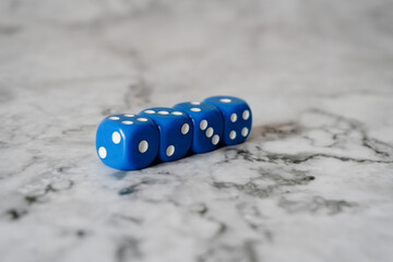 rolling dice on the white marble table surface