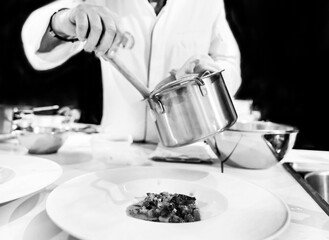 Chef cooking in a kitchen, chef at work, Black and White.