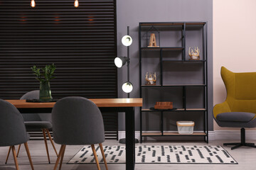 Stylish room interior with comfortable furniture and shelving unit. Modern design