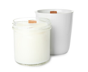 Beautiful candles with wooden wicks on white background