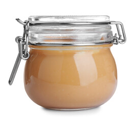 Delicious peanut butter in glass jar isolated on white