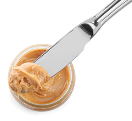 Glass bowl and knife with tasty peanut butter on white background, top view
