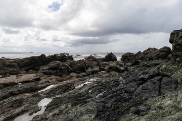Fototapeta na wymiar Scattered rock formation of Flynns Beach, Port Macquarie, Australia.