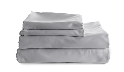 Stack of clean silky bed linen isolated on white