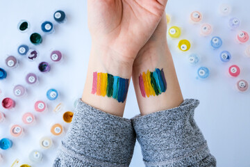 Rainbow LGBTQ flag painted on hand. Support for lgbt community. Honour of pride month. Connecting...