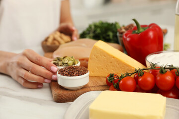 Woman with different products at table, closeup. Keto diet