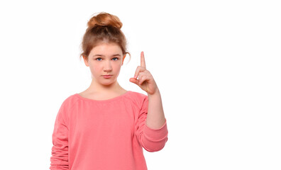 Portrait of Serious young girl showing index finger and says: Attention please, dressed in pink...