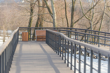 Smooth wooden descent to the river in Kapotna. Multi-level smooth descent. Wooden benches on a wooden path