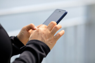 Asian woman using smartphone outdoors