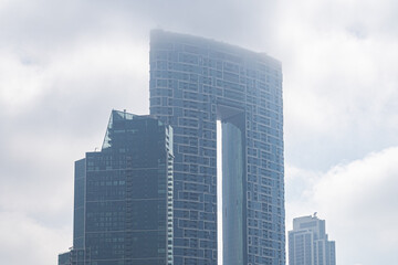 Modern architecture sky scrapers on a foggy day - 427380247