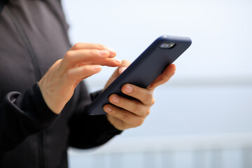 Asian woman using smartphone outdoors