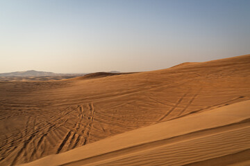 andscape of desert dunes at sunset on a windy day - 427380462