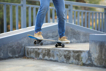 Asian woman skateboarder skateboarding at skatepark