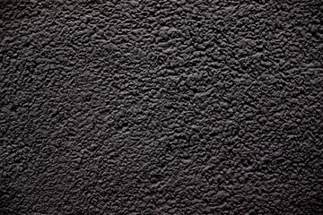 Concrete black wall background on the street.