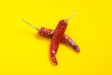 Dry Red chilli on yellow background.