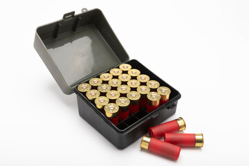 12-gauge shotgun bullet shells and plastic box on white background