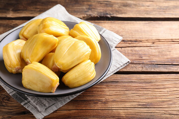 Delicious exotic jackfruit bulbs on wooden table