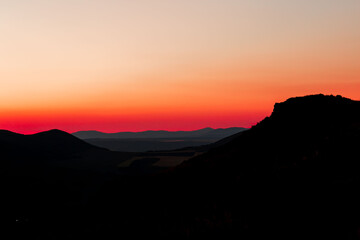 Red sunset with mountain silhouette. Scenery with mointains in sunset.