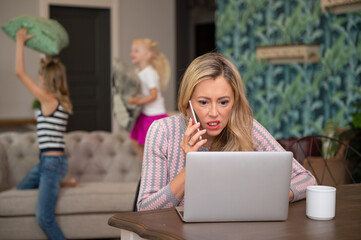 Woman in stress because kids distract her from work