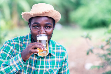 Happy African man drinking ice beer
