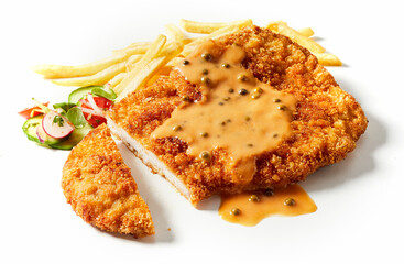 Sliced schnitzel with sauce and vegetables