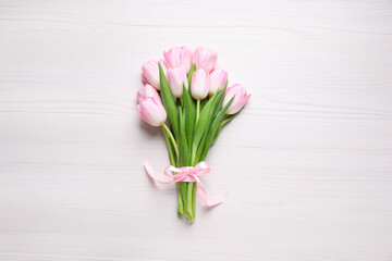 Beautiful pink spring tulips on white wooden background, top view