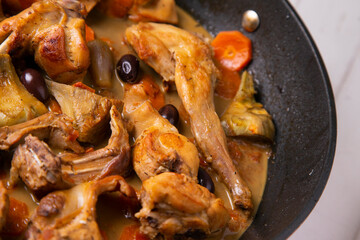 Wild rabbit cocked with artichokes and black olives. Traditional tapa from south spain.