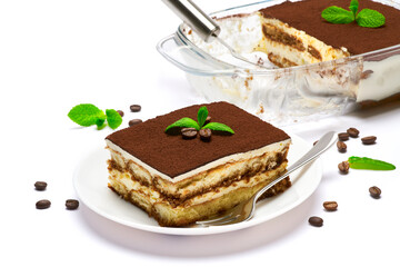 Traditional Italian Tiramisu dessert in glass baking dish, portion on plate and scapula isolated on white background