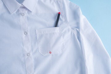 Red ink stain on white shirt. on a blue background