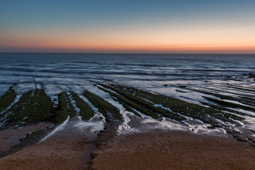 Rock formation goes into the sea at Praia Da Magoito
