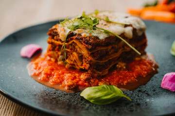 Italian lasagne home made lasagna, lazania z miesem, domowa lazania, lasagne, Italian Beef Lasagna Lasagne with bolognese meat sauce, bechamel, cheese and basil on white board. lazzania domowej roboty © Silesia