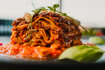 Italian lasagne home made lasagna, lazania z miesem, domowa lazania, lasagne, Italian Beef Lasagna Lasagne with bolognese meat sauce, bechamel, cheese and basil on white board. lazzania domowej roboty © Silesia