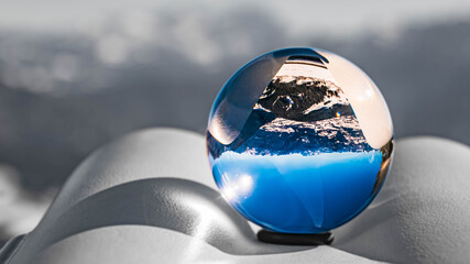 Crystal ball alpine landscape shot on a telescope with black and white background outside the sphere at the famous Rossfeldstrasse panorama street, Berchtesgaden, Bavaria, Germany
